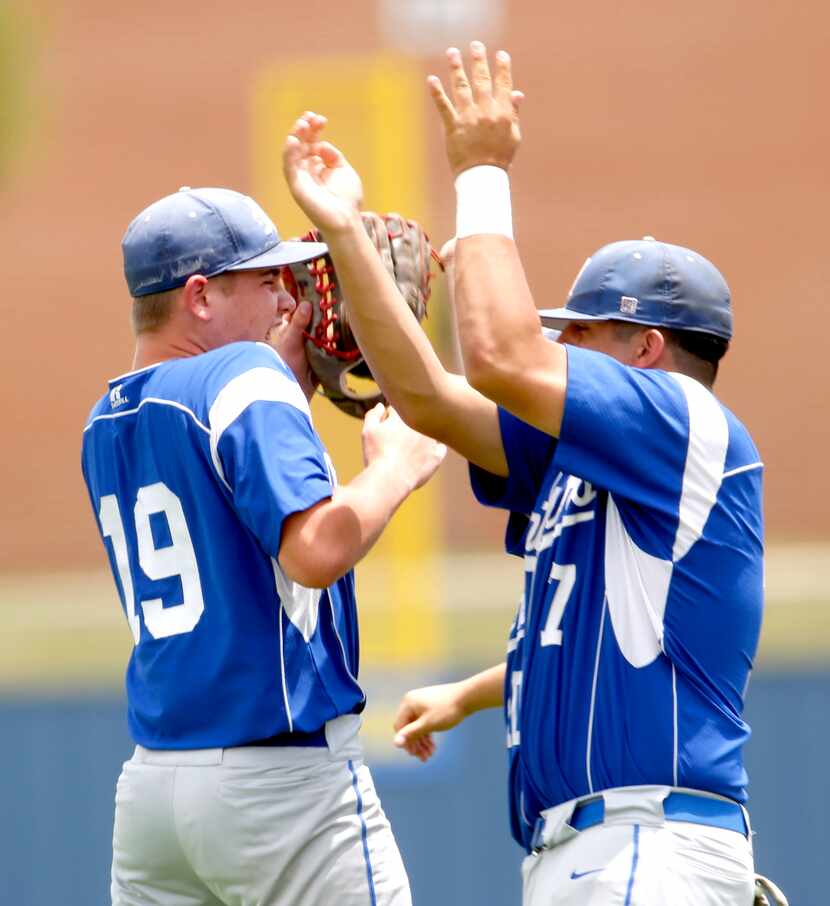 Midlothian pitcher Caden Hawkins (19) receives congratulations from teammate Anthony...