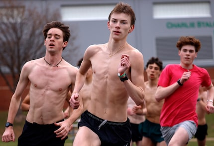 Southlake Carroll track runner Caden Leonard (center) works out with his teammates as they...