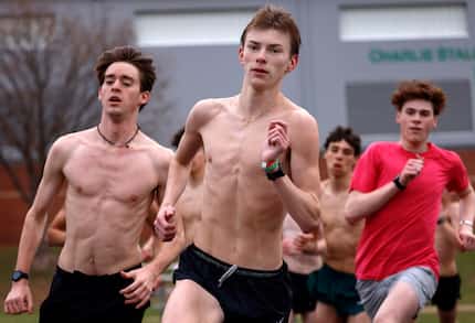Southlake Carroll track runner Caden Leonard (center) works out with his teammates as they...