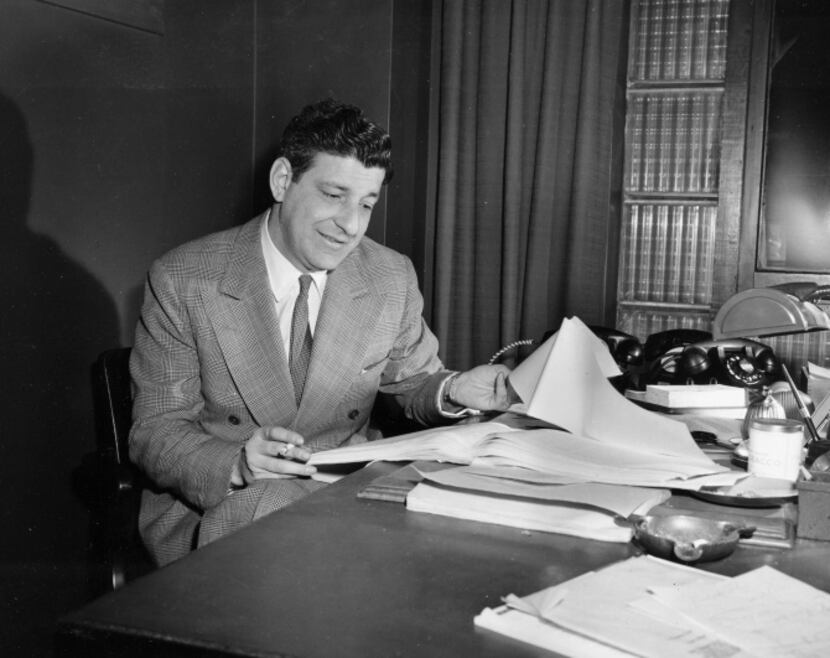 Book publisher Roger Straus is shown at his desk in his office in New York City, March 10,...
