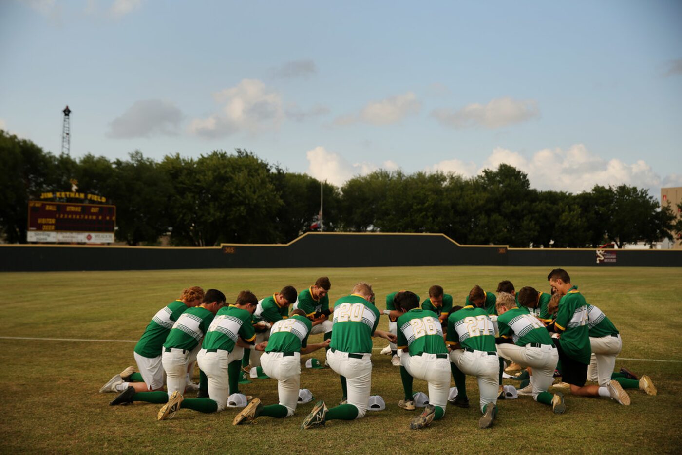 Santa Fe players join hands before the second game of the best-of-three series in the Class...