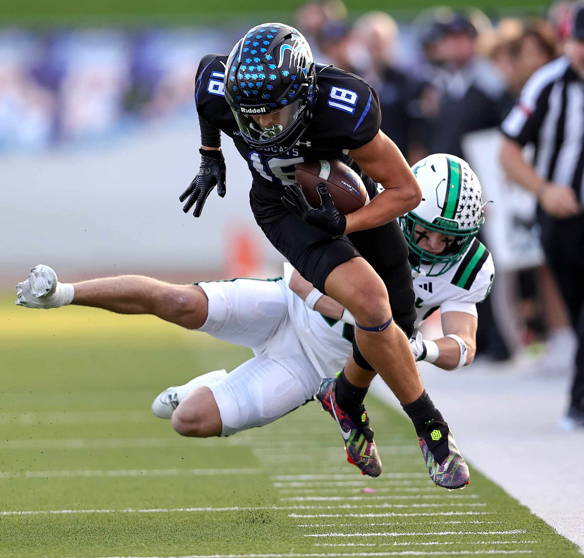 Byron Nelson wide receiver Ezra Malamura (18) tries to break a tackle from Southlake Carroll...