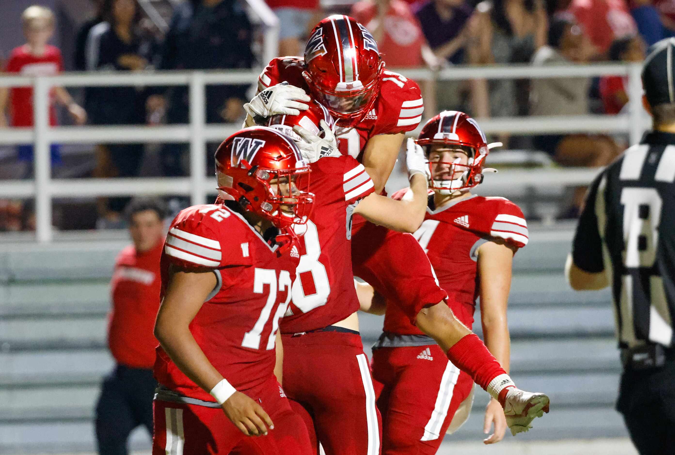 Woodrow Wilson wide receiver Graydon Thompson (18) is celebrated by his teammates for his...