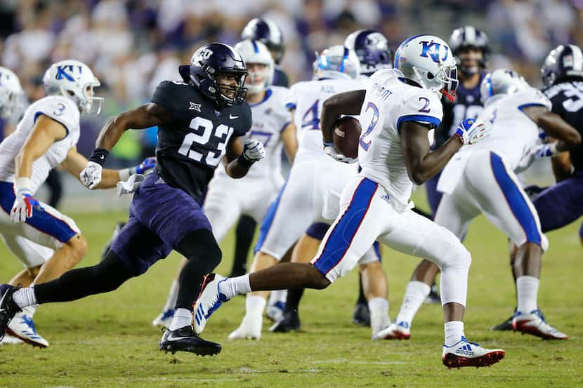 TCU Horned Frogs linebacker Alec Dunham (23) pursues Kansas Jayhawks wide receiver Daylon...