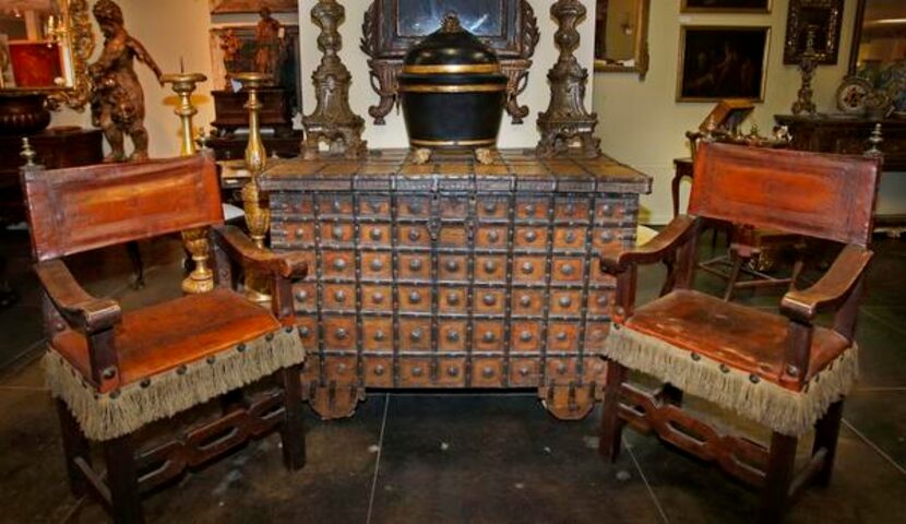 
At the Mews, the Antique Co. booth features a Spanish armada chest flanked by Italian...