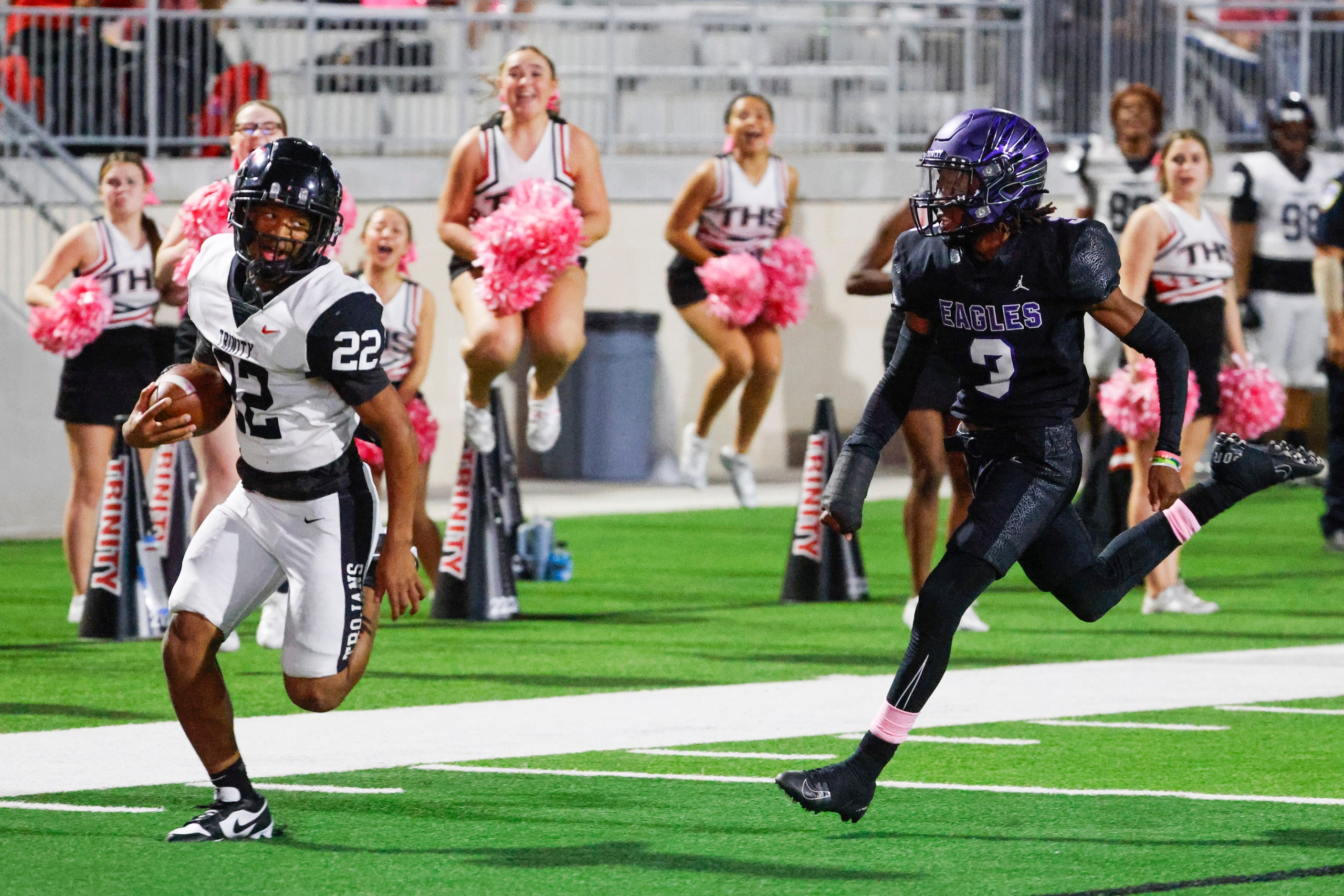 Trinity High’s JT Harris (left) looks back as he runs past Crowley High’s Ja’Corian White to...