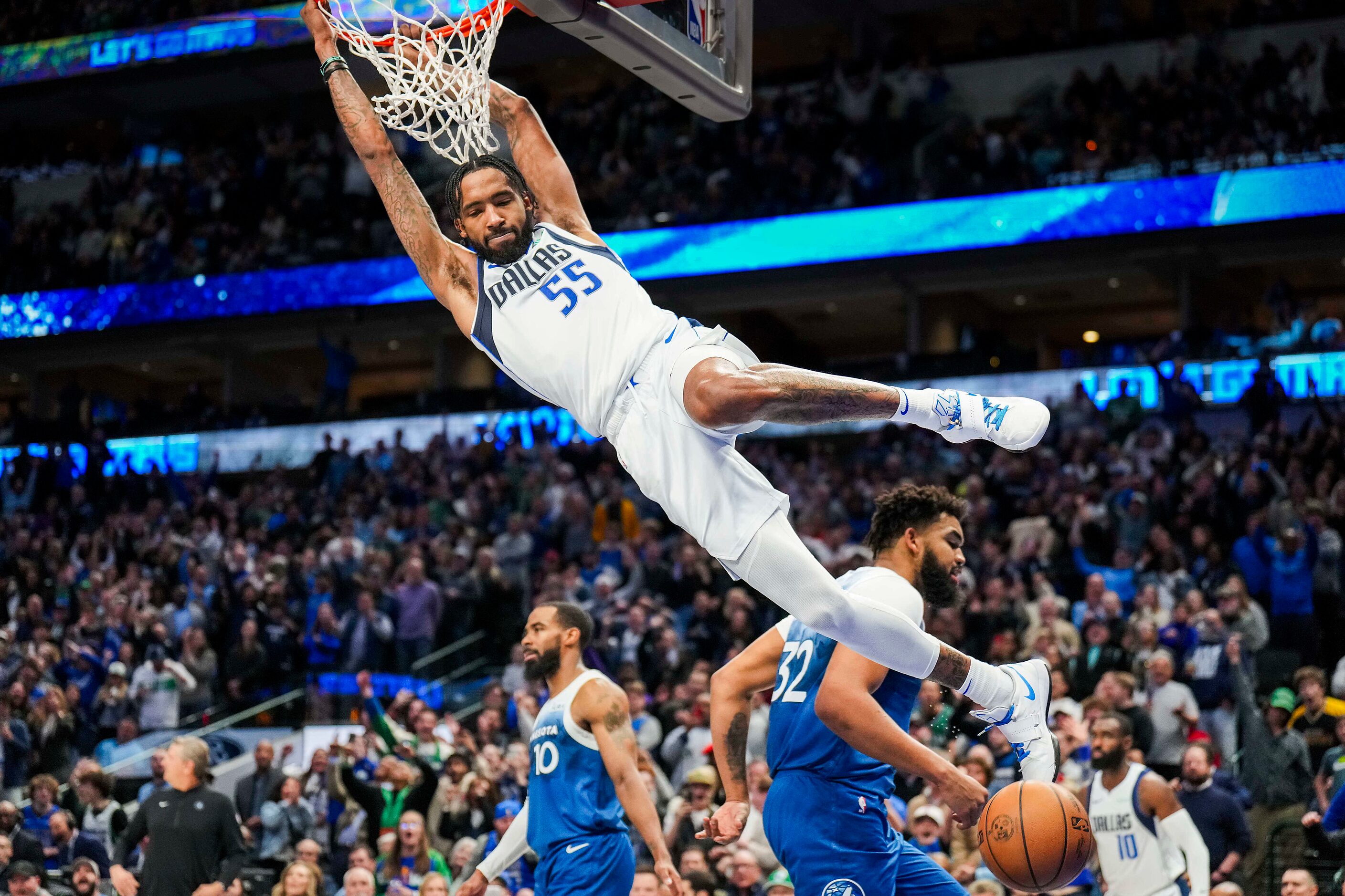 Dallas Mavericks forward Derrick Jones Jr. (55) dunks the ball over Minnesota Timberwolves...