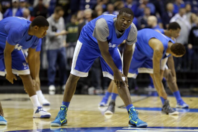 Kentucky's Julius Randle stretches during practice for their NCAA Midwest Regional semifinal...