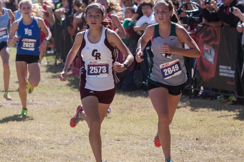 Southlake Carroll's Cate Tracht (right) is pictured running in the UIL cross country state...