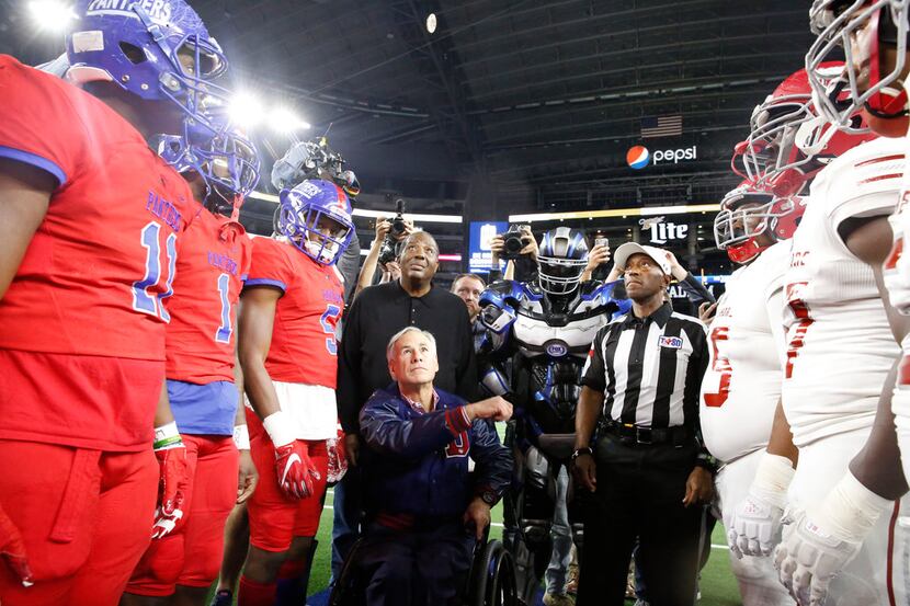 Texas State Govenor Greg Abbott flips the coin before Duncanville's game with Galena Park...