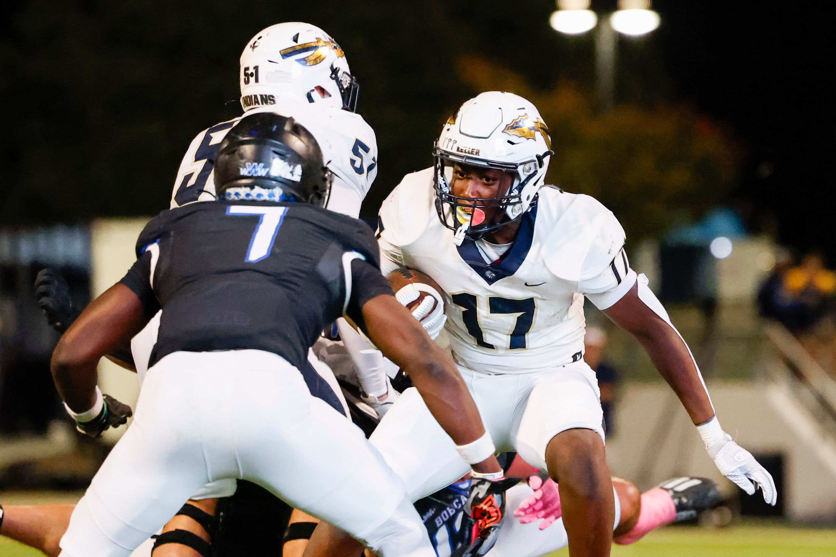 Keller High’s Kaleb Malzac (17) tries to run past Byron Nelson’s David Kabongo (front)...