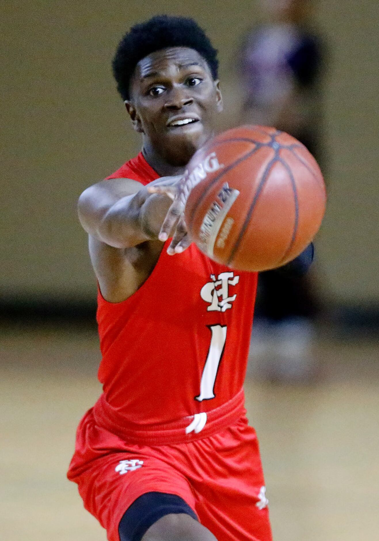 Cedar Hill High School guard Dawaun Mims (1) passes the basketball during the first half as...