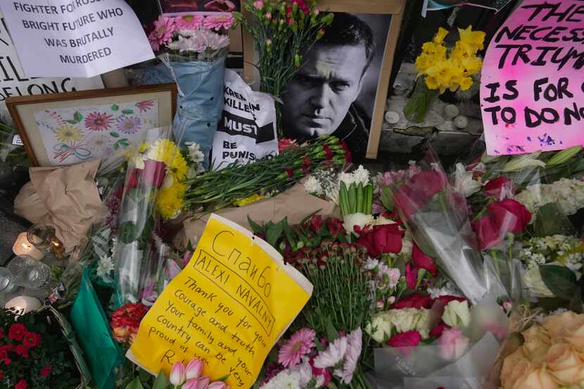 Flowers and portraits are left opposite the Russian Embassy in London on Monday, Feb. 19,...