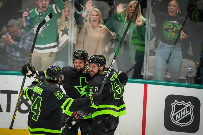 Dallas Stars center Tyler Seguin (91) celebrates with left wing Jamie Benn (14) and right...