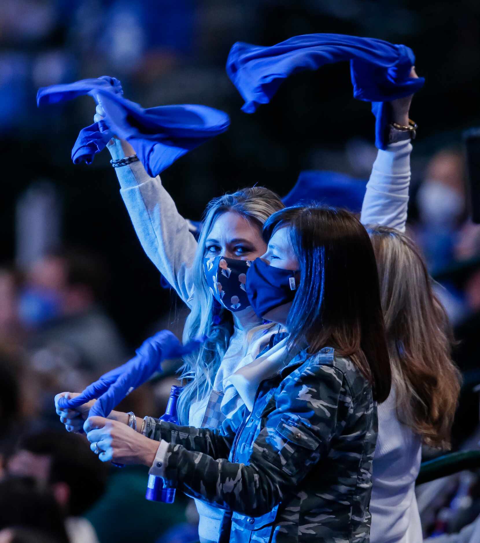 Fans, mostly consisting of healthcare workers, cheer on the Dallas Mavericks during an NBA...