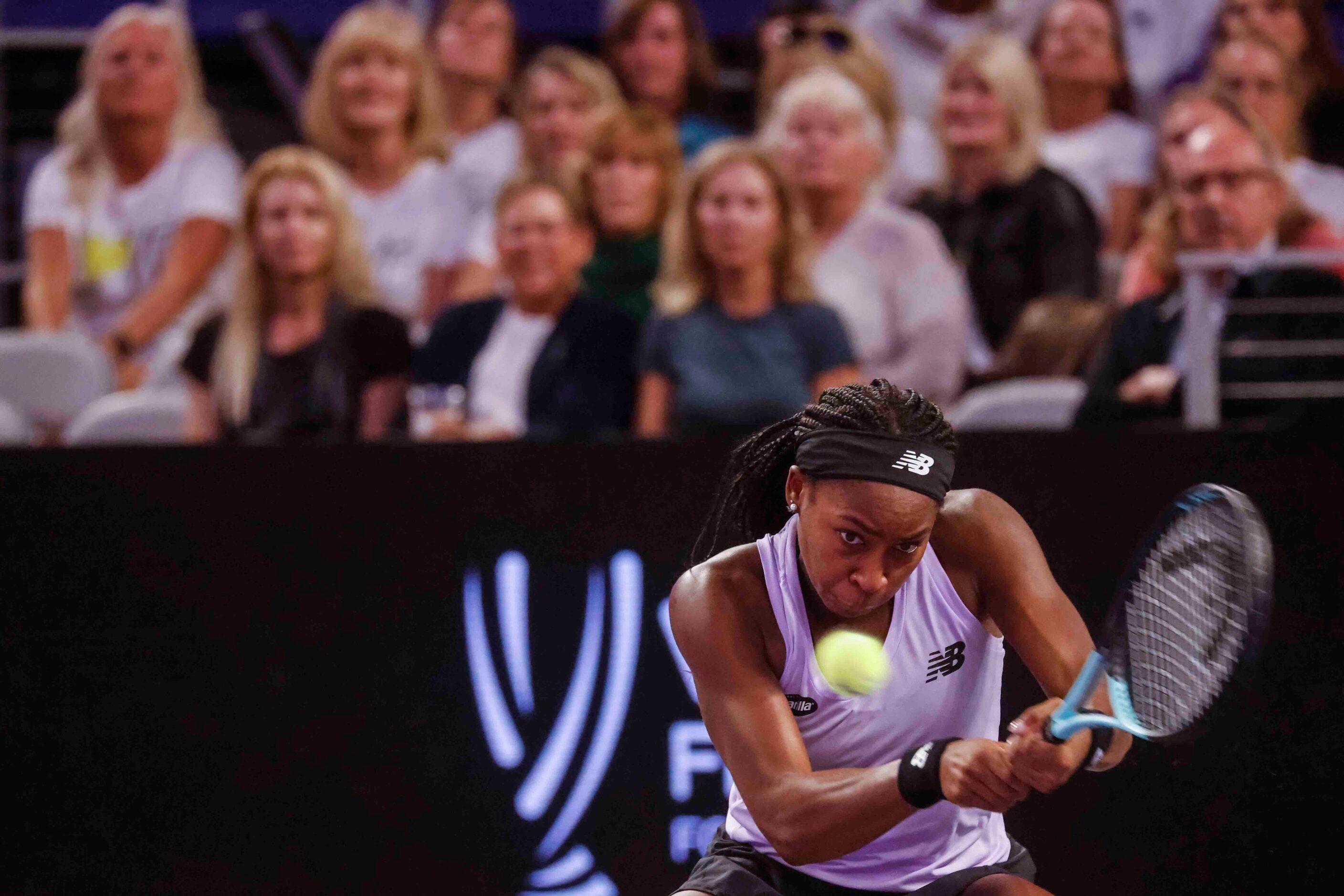 Coco Gauff of the USA plays a backhand shot against Caroline Garcia of France on day two of...