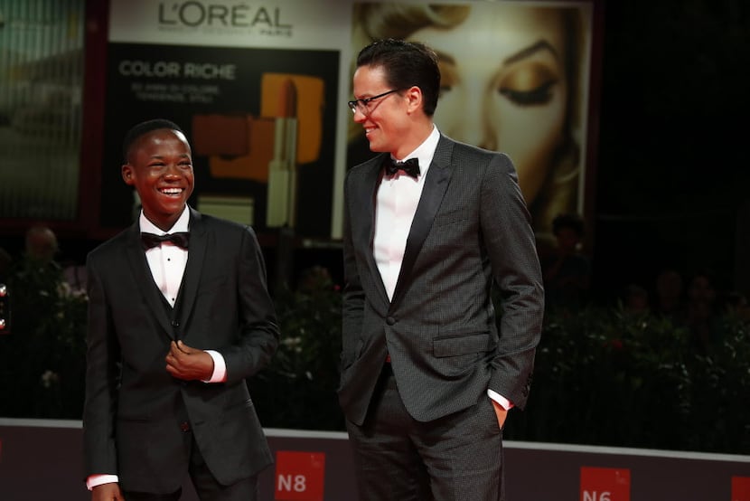 Abraham Attah and Cary Fukunaga pose for photographers on the red carpet before Beasts of No...
