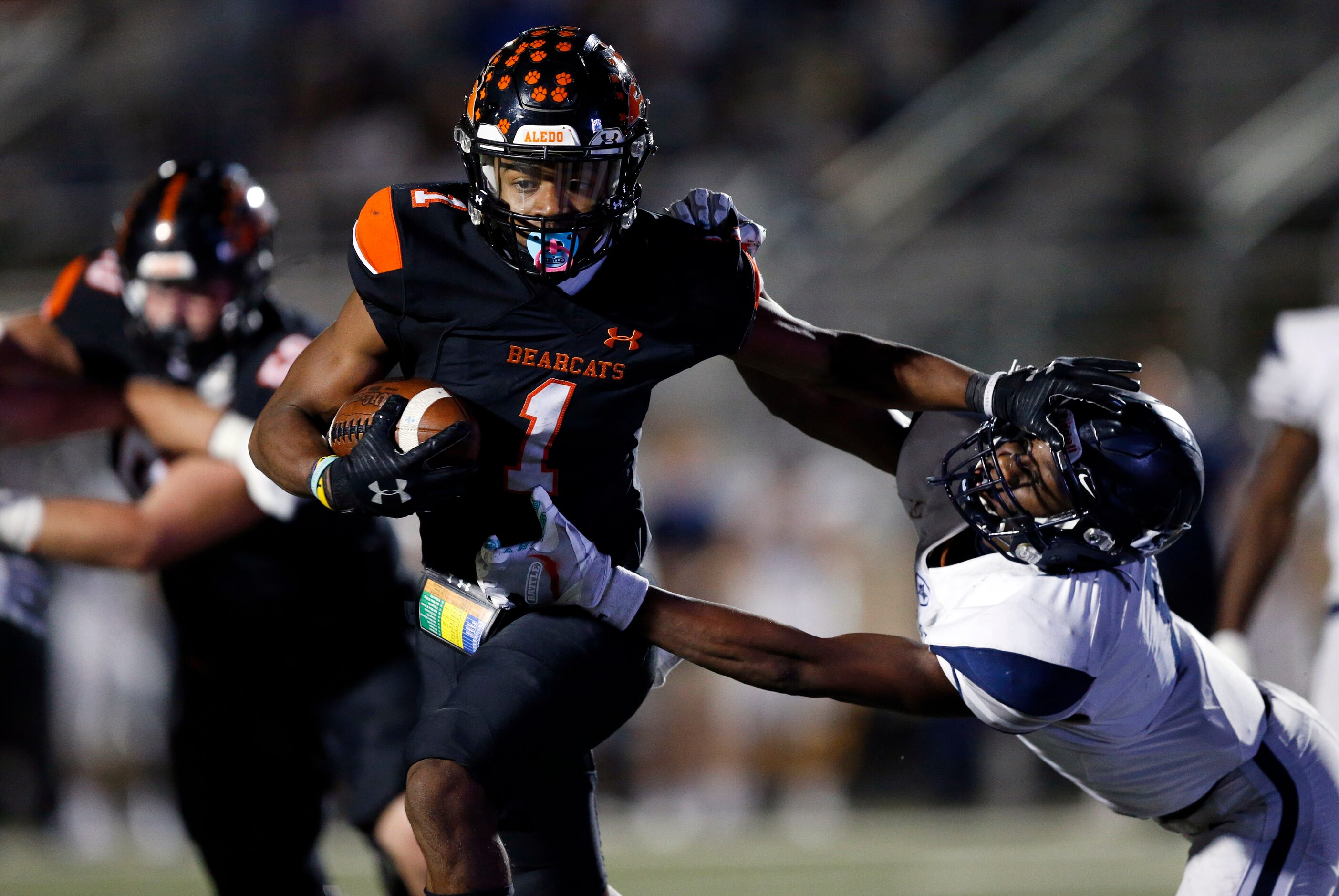 Aledo receiver JoJo Earle (1) gives a stiff arm to Frisco Lone Star linebacker Devin Turner...