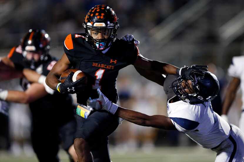 Aledo receiver JoJo Earle (1) gives a stiff-arm to Frisco Lone Star's Devin Turner during a...