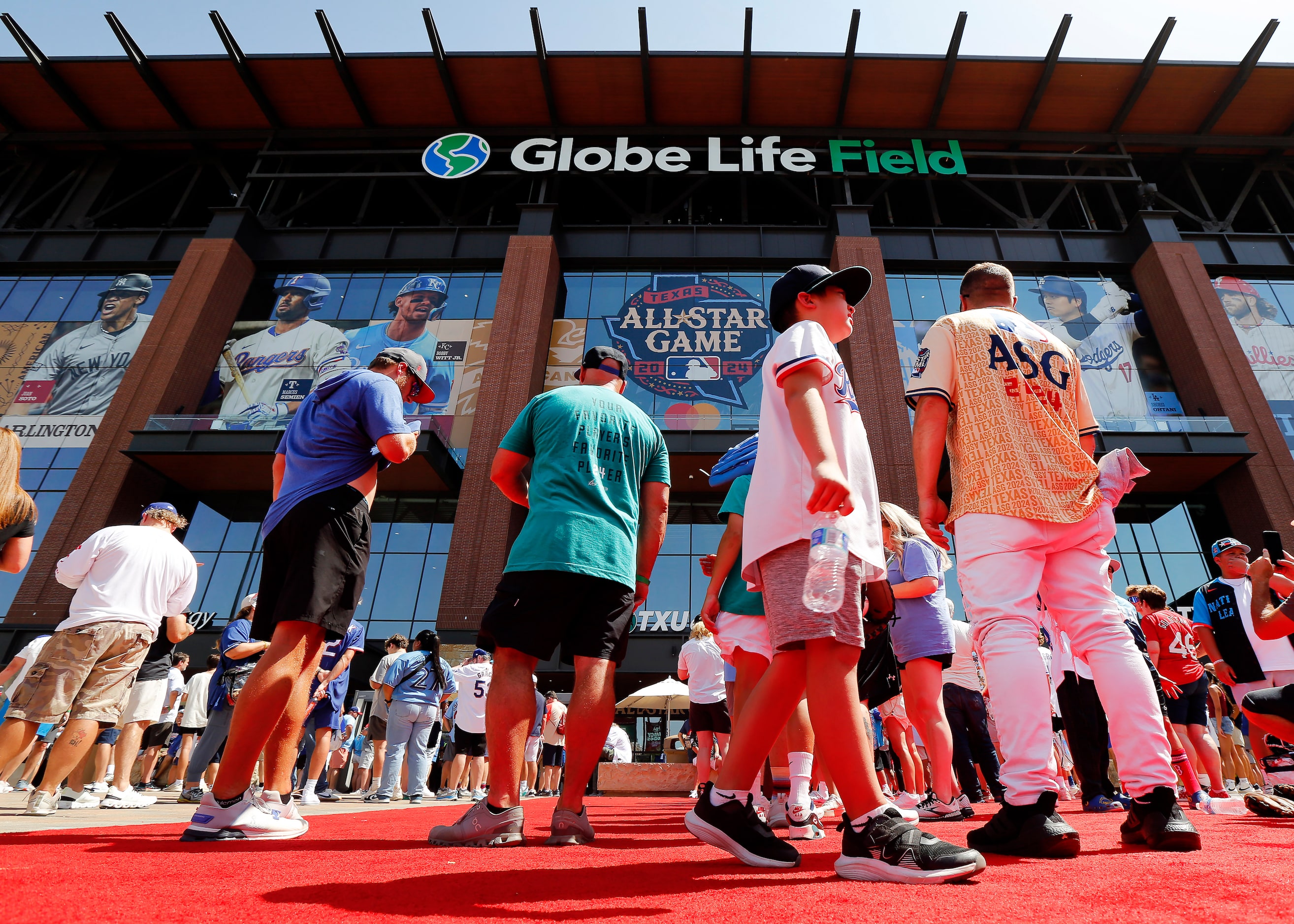 Baseball fans Nathan Larmon of Dallas (right) and his son Schafer Lancaster (second from...