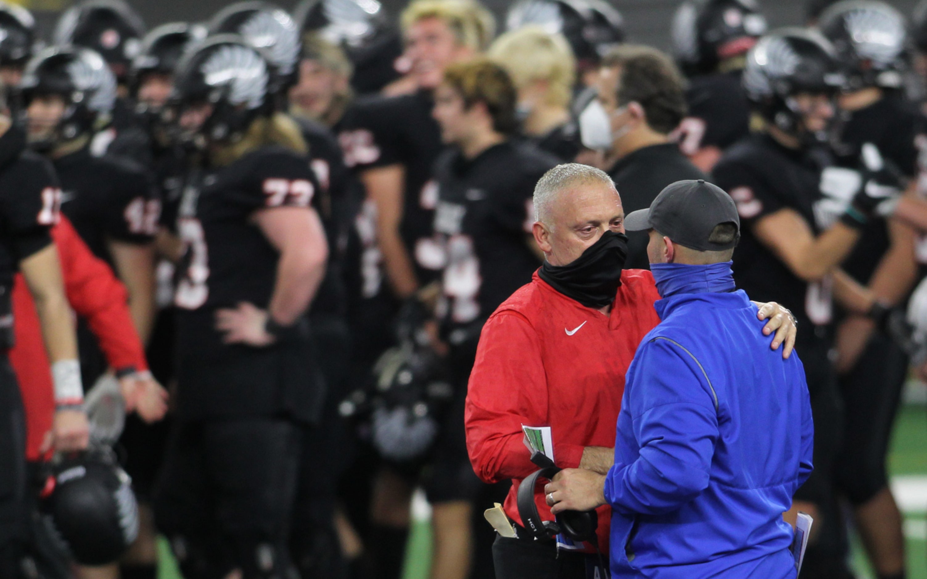 Argyle head coach Todd Rodgers, left, greets Lindale head coach Chris Cochran at midfield...