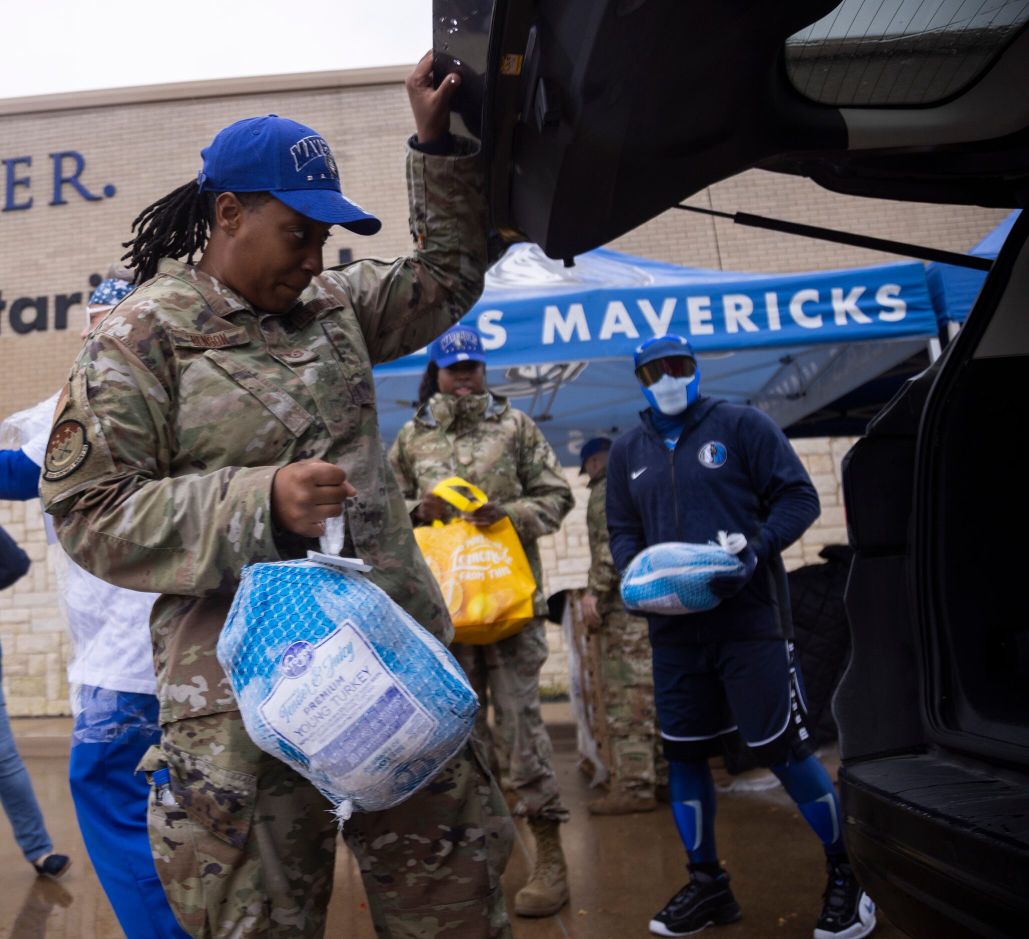 Technical Sergeant (TSgt) Ebony Denson with the 301st AMXS loads a turkey into the back of a...