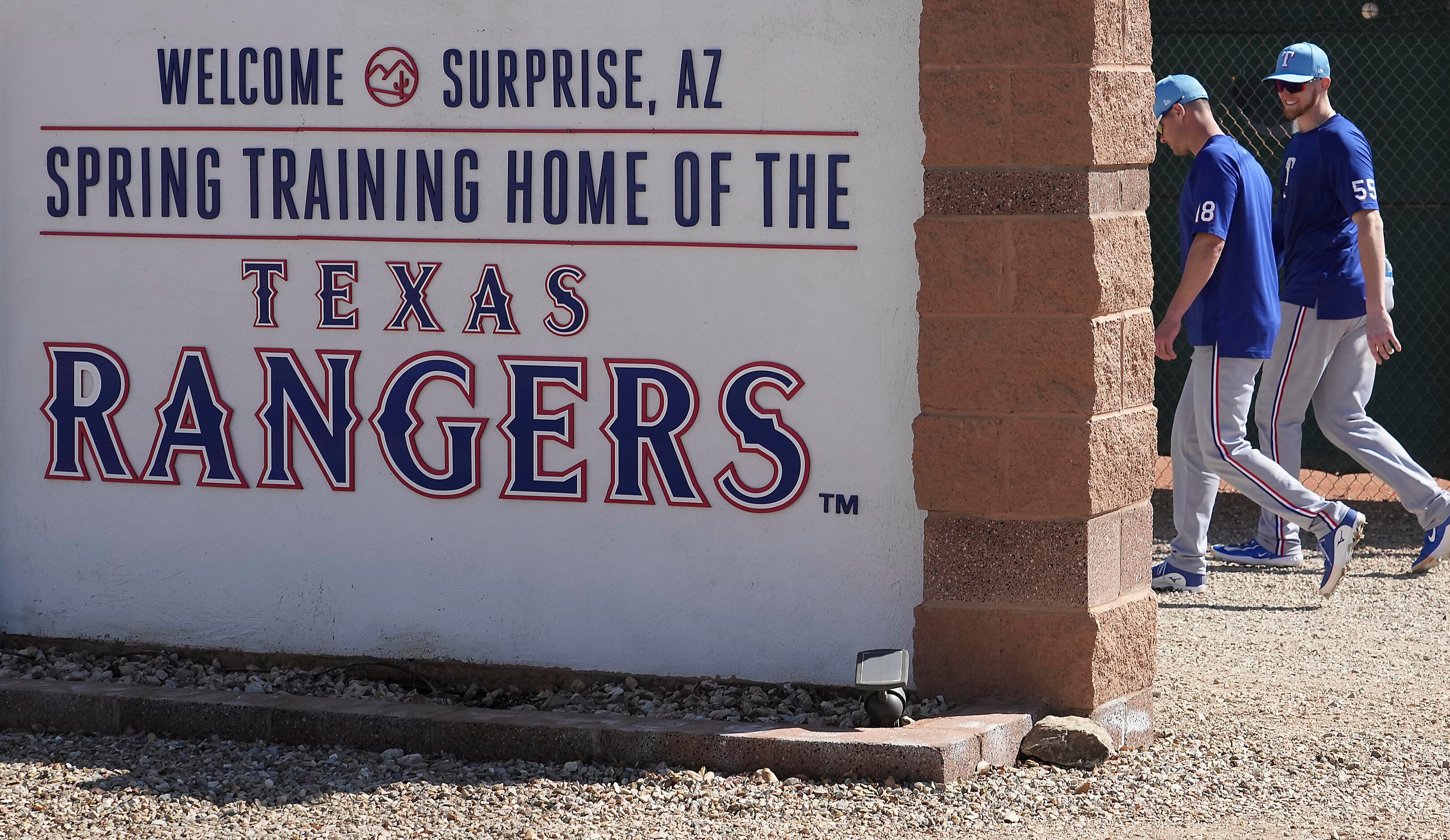 Texas Rangers catchers Andrew Knapp (18) and Sam Huff (55) walk to the clubhouse after the...