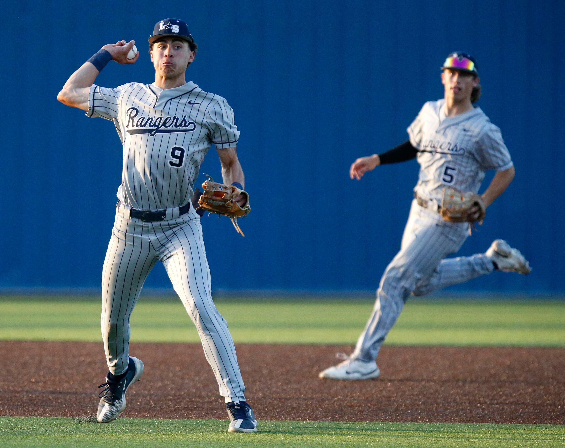 Lone Star High School shortstop Caleb Reynolds (9) makes a throw to first base in the third...