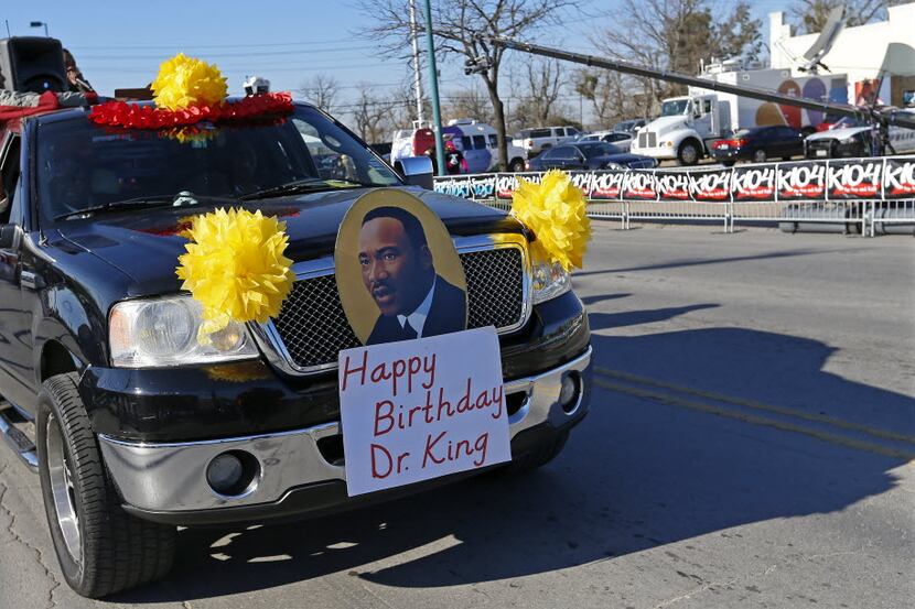 A pickup truck with a sign honoring Martin Luther King Jr. participates in the annual MLK...