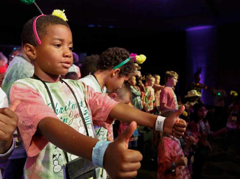 Micah Wilson, 7,  performs in the show "Christmas in July" finale with fellow campers at...