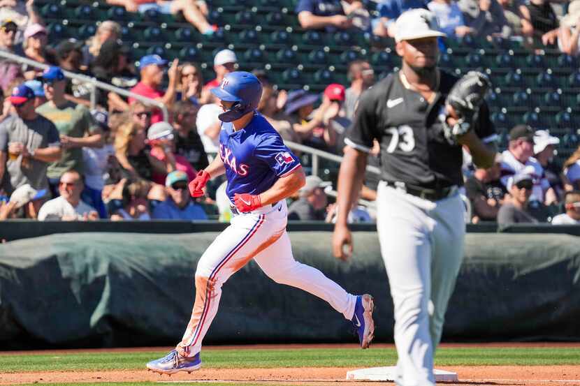 Texas Rangers outfielder Wyatt Langford rounds the bases after hitting a two-run home run...