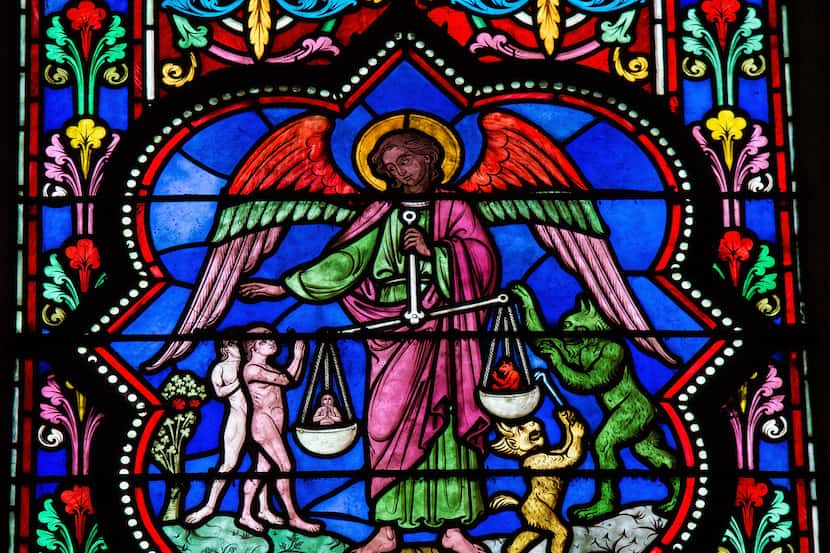Stained glass window depicting Saint Michael the Archangel at the Final Judgement, in...
