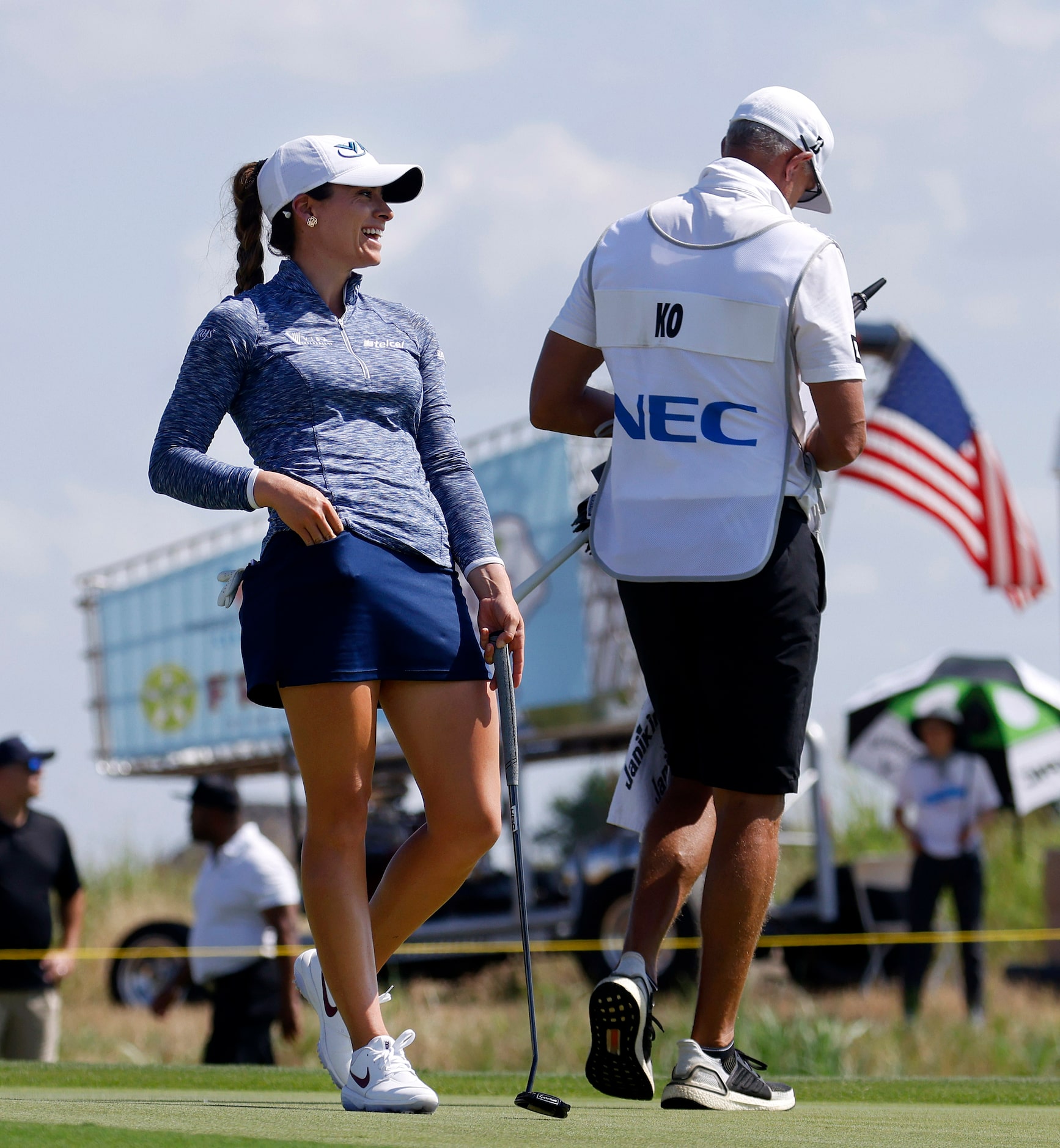 Professional golfer Gaby Lopez laughs with Jin Young Ko's caddie as she waits to putt on No....