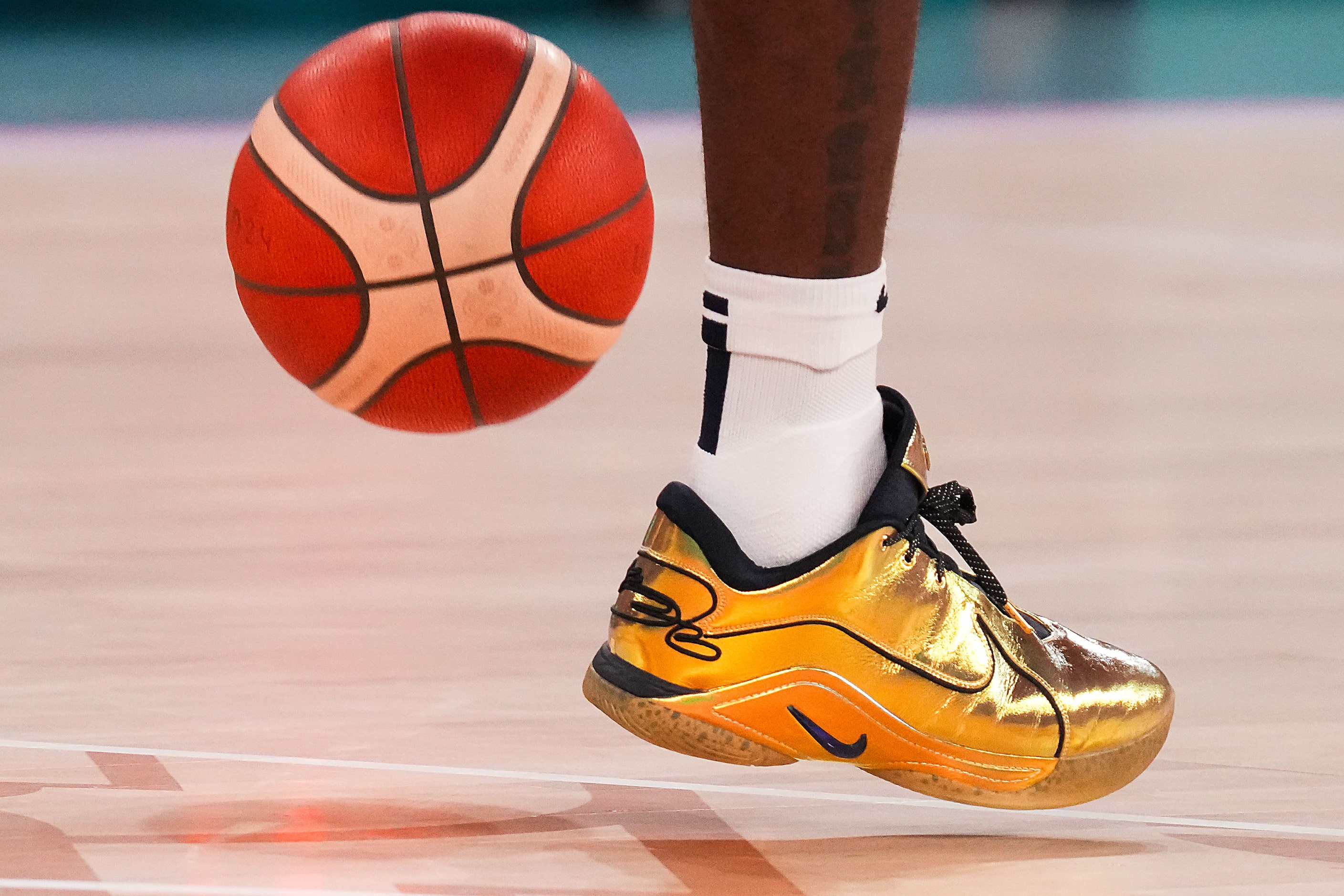 Lebron James of the United States wears gold shoes during the men's gold medal basketball...