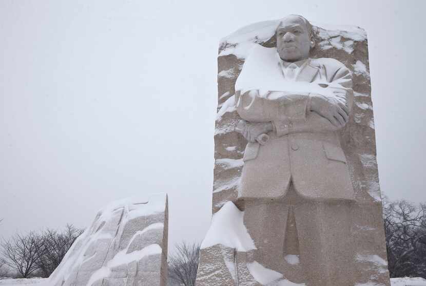  The Martin Luther King, Jr. Memorial is seen with a coating of snow, Saturday, Jan. 23,...