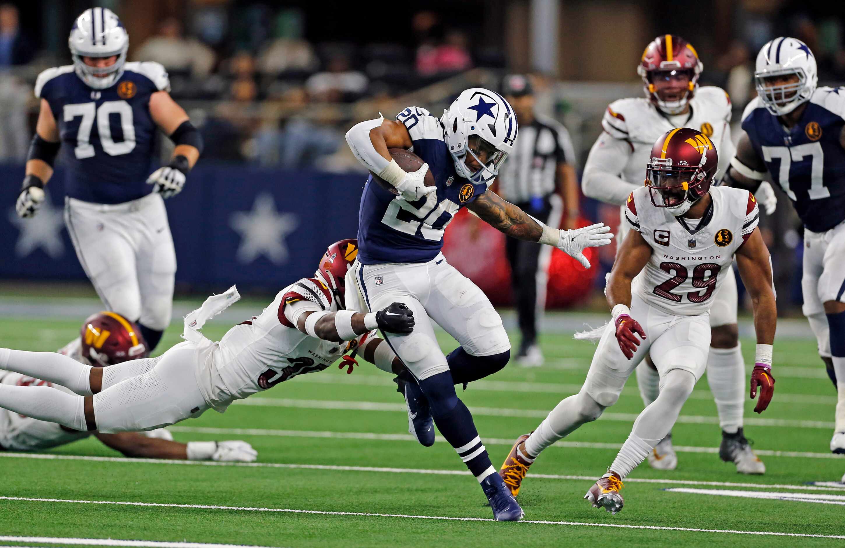 Dallas Cowboys running back Tony Pollard (20) picks up a first down in heavy traffic during...