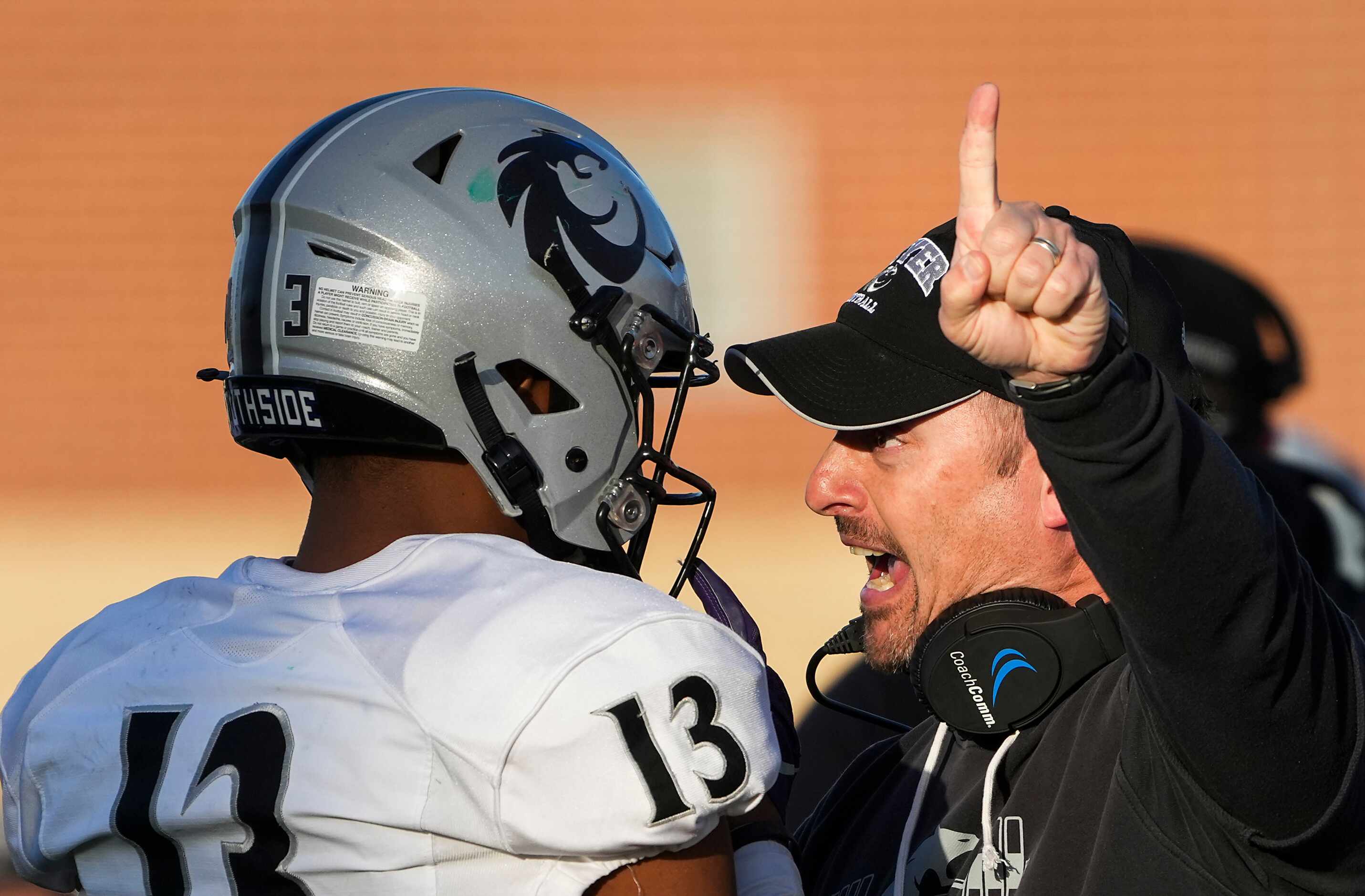 Denton Guyer head coach Reed Heim instructs defensive back Anthony Benford (13) on the...
