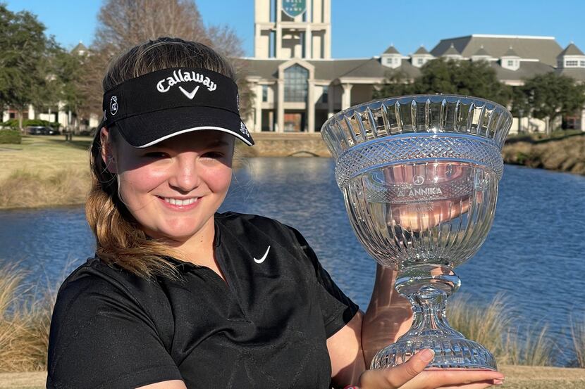 Avery Zweig holds up her trophy from the American Junior Golf Association’s Annika...