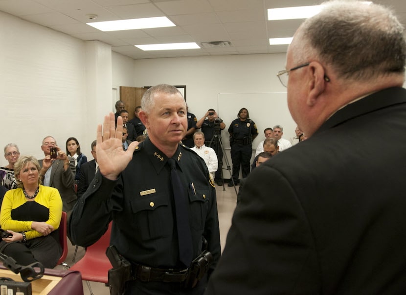  Craig Miller, left, the new DISD police chief, takes the oath of office from Assistant...