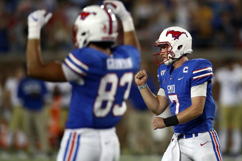 Shane Buechele (7) and Kylen Granson of the Southern Methodist Mustangs celebrates a...