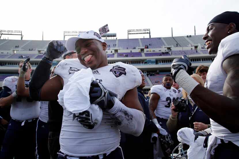 Rice University #57 Cameron Nwosu, center, dances as he celebrates victory with other...