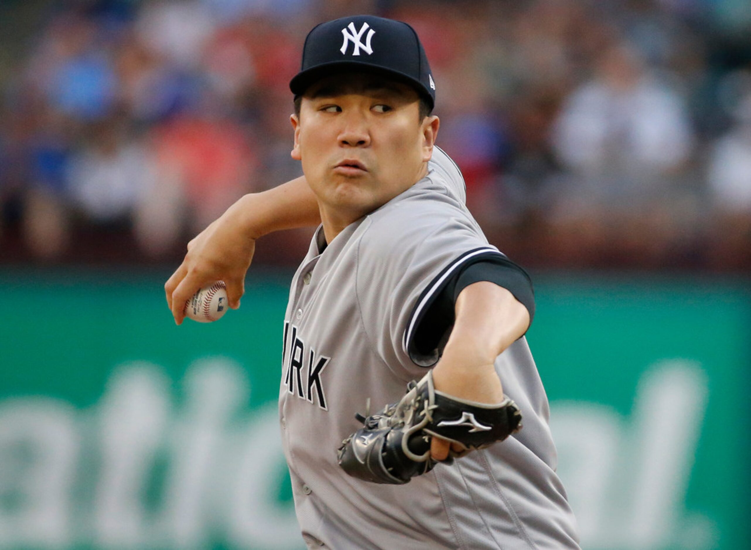 New York Yankees starting pitcher Masahiro Tanaka (19) throws a first-inning pitch during...