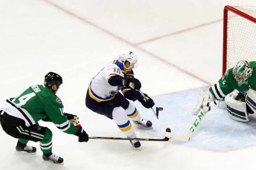 St. Louis Blues right wing Scottie Upshall (10) tries to deflect a pass past Dallas Stars...