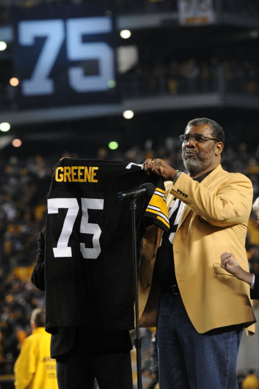 Former Pittsburgh Steelers defensive lineman Joe Greene holds a jersey at a ceremony where...