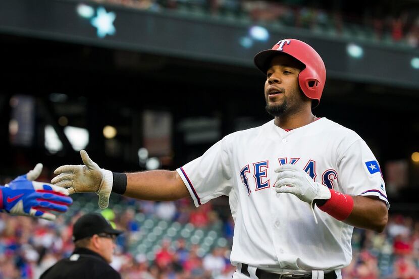Texas Rangers shortstop Elvis Andrus celebrates after scoring during the first inning...