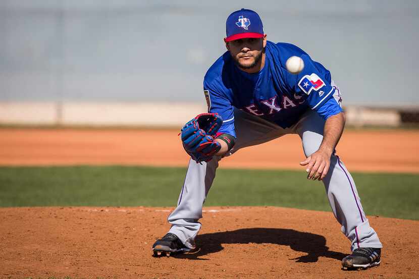 Texas Rangers pitcher Martin Perez participates in fielding practice during a spring...