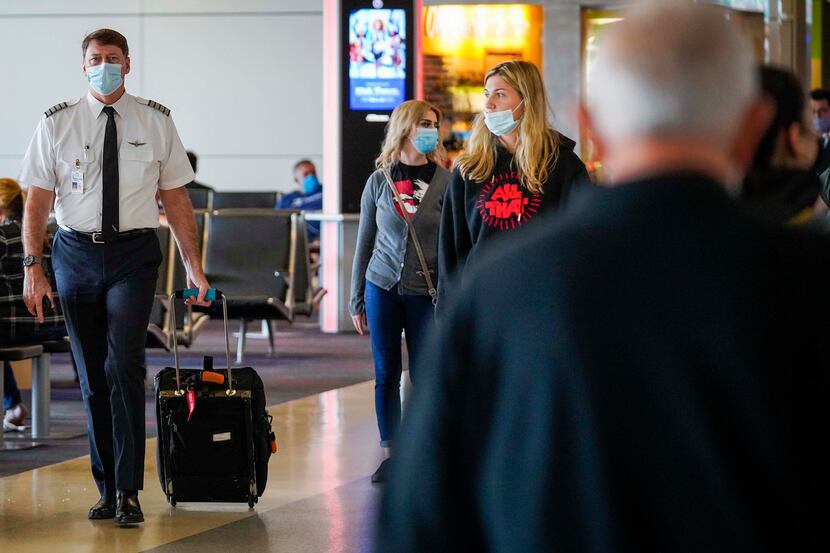 A pilot walks on the councourse at DFW International Airport on Tuesday, June 30, 2020, in...