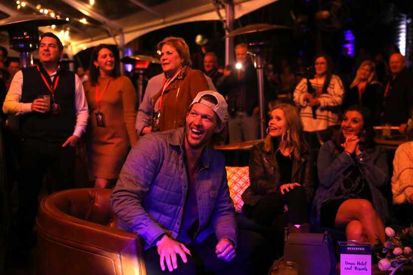 Clayton Kershaw (center) and Ellen Kershaw, far right, smile back at Brad Paisley on stage...