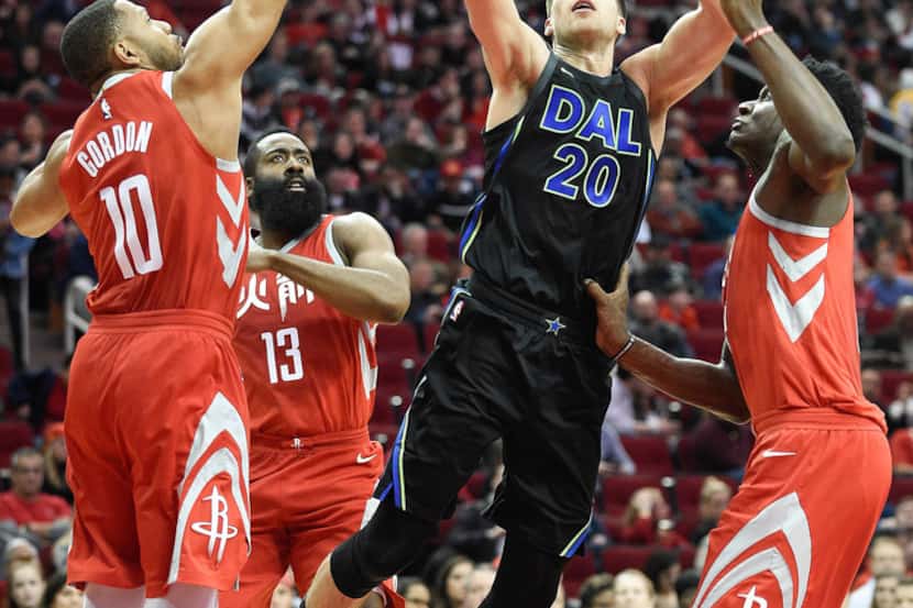 Dallas Mavericks forward Doug McDermott (20) shoots as Houston Rockets guard Eric Gordon...