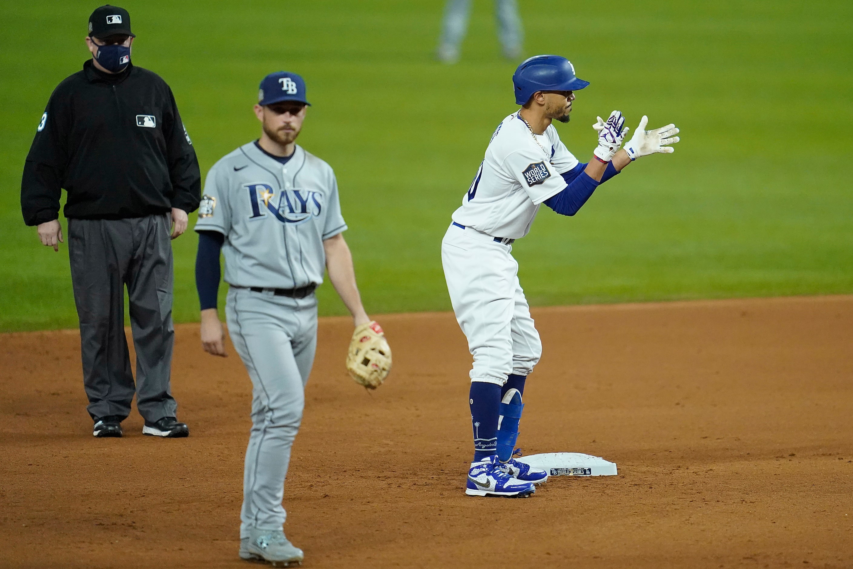 Los Angeles Dodgers right fielder Mookie Betts celebrates after hitting a double during the...